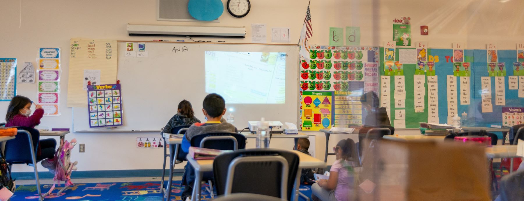  A group of students sitting at desks in a classroom.
